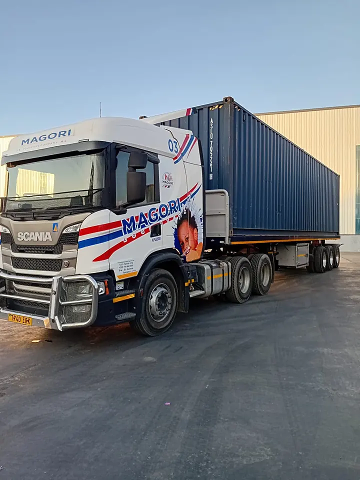 A Magori Logistics truck with a container at a warehouse