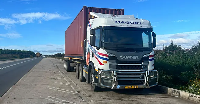 A Magori Logistics truck carrying a loaded container