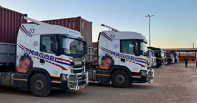 Several Magori Logistics trucks with containers in the yard